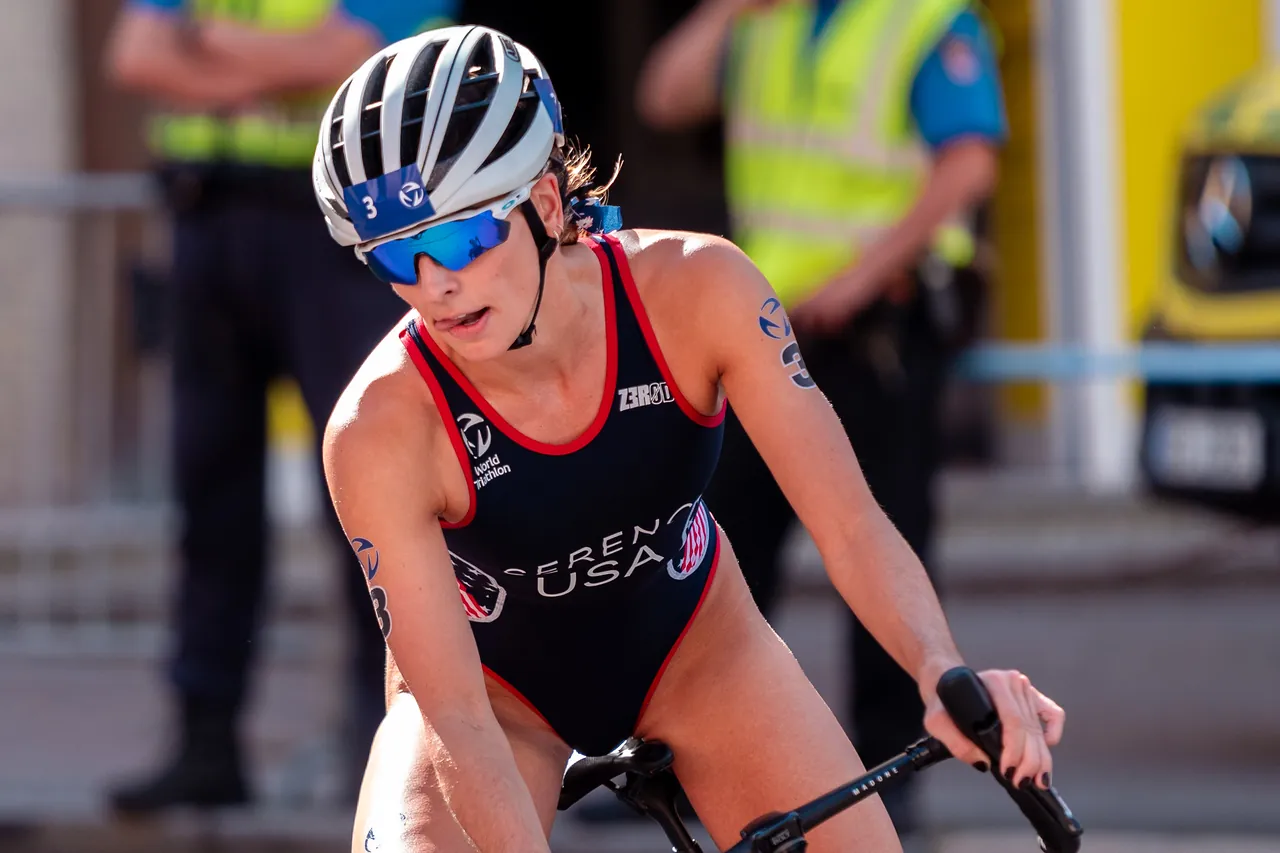 Gina Serrano cycling in USA triathlon kit at World Triathlon event